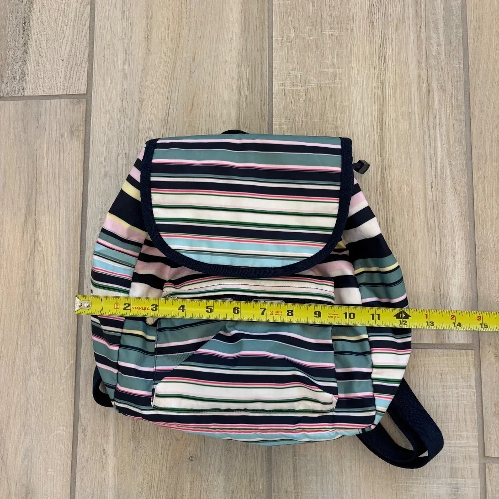 LeSportsac Voyager drawstring backpack in a navy pastel stripe pattern.